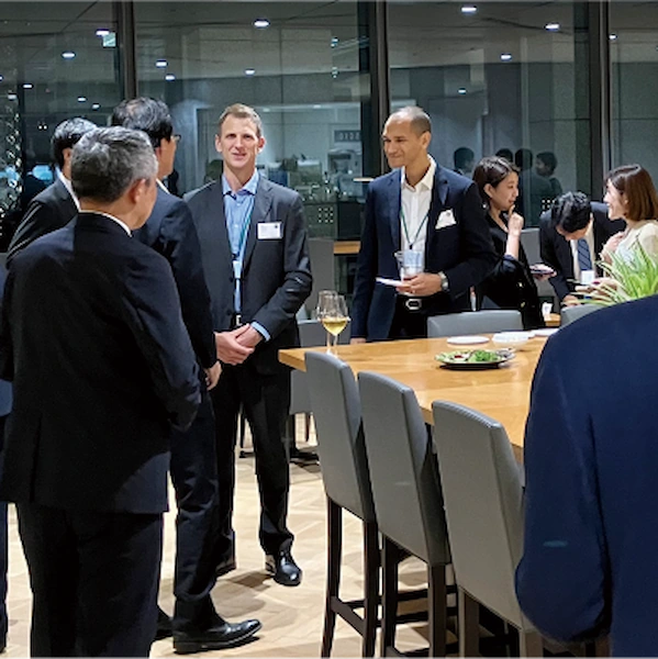 AP Venturesと日本企業とのワークショップにて、飲み物を手に和やかに談笑する参加者たちの様子。